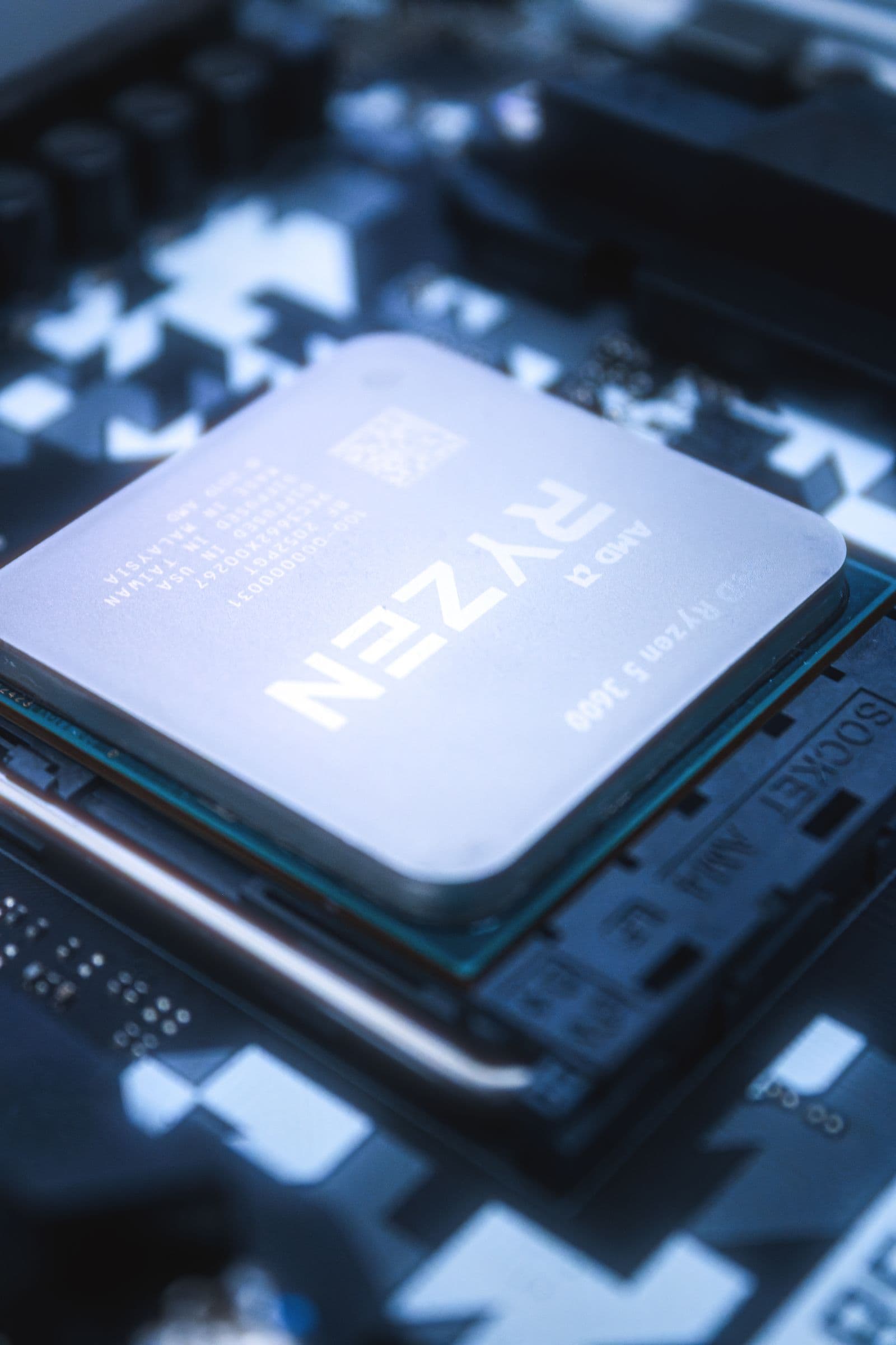 A close-up of an AMD Ryzen CPU seated on a motherboard socket
