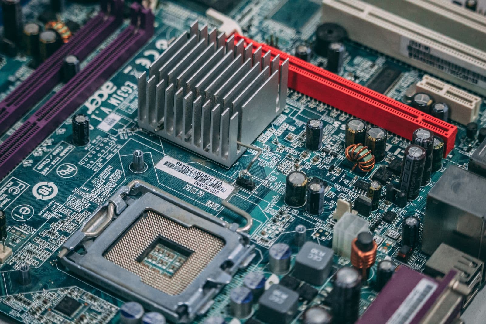 Close-up of a gaming motherboard showing heatsink covers, M.2 slot shields, and VRM power delivery components