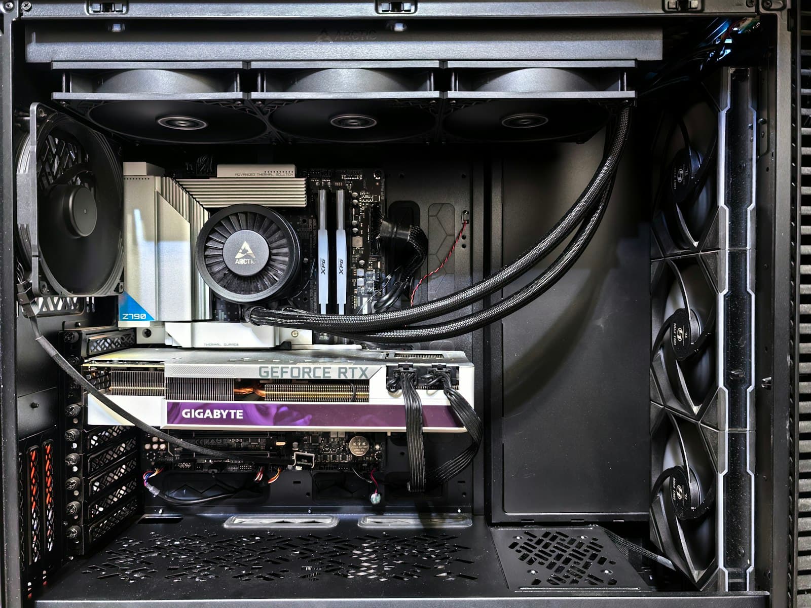 Large graphics card installed inside an open PC case, showing its substantial length relative to the case fans and frame
