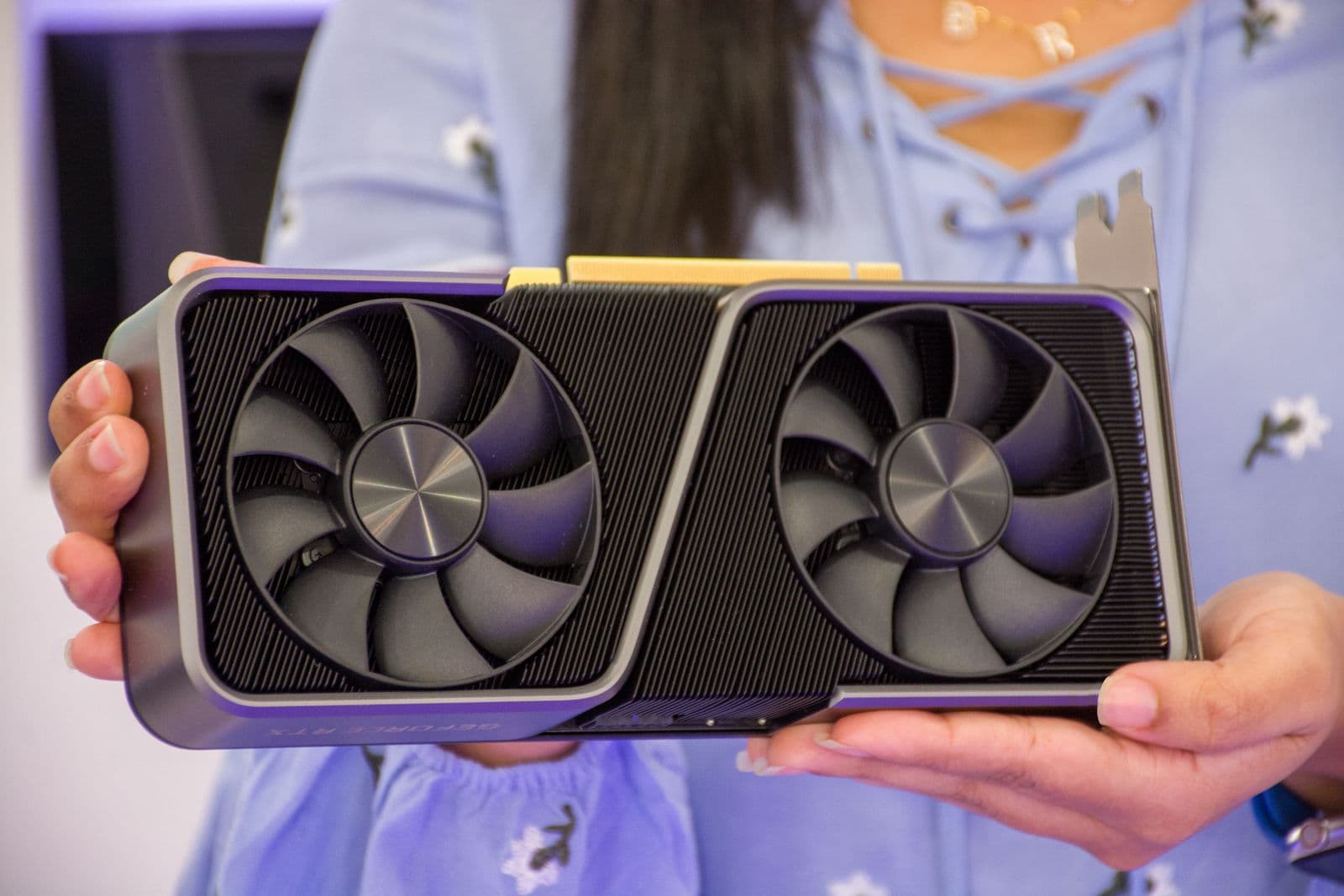 Hands holding a graphics card before installation