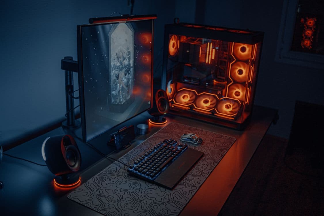 A bright gaming desk setup with a monitor and keyboard, representing the kind of PC build that handles Minecraft at high frame rates