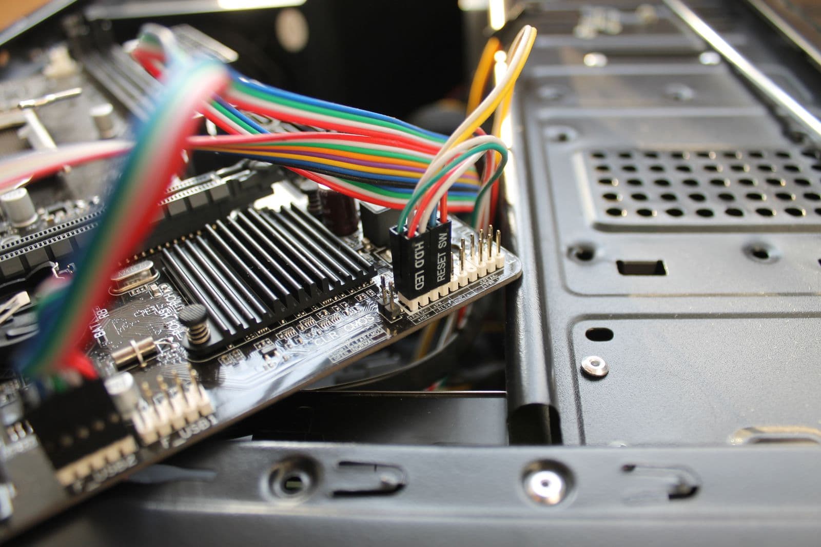 Close-up of motherboard with colorful wiring and connectors