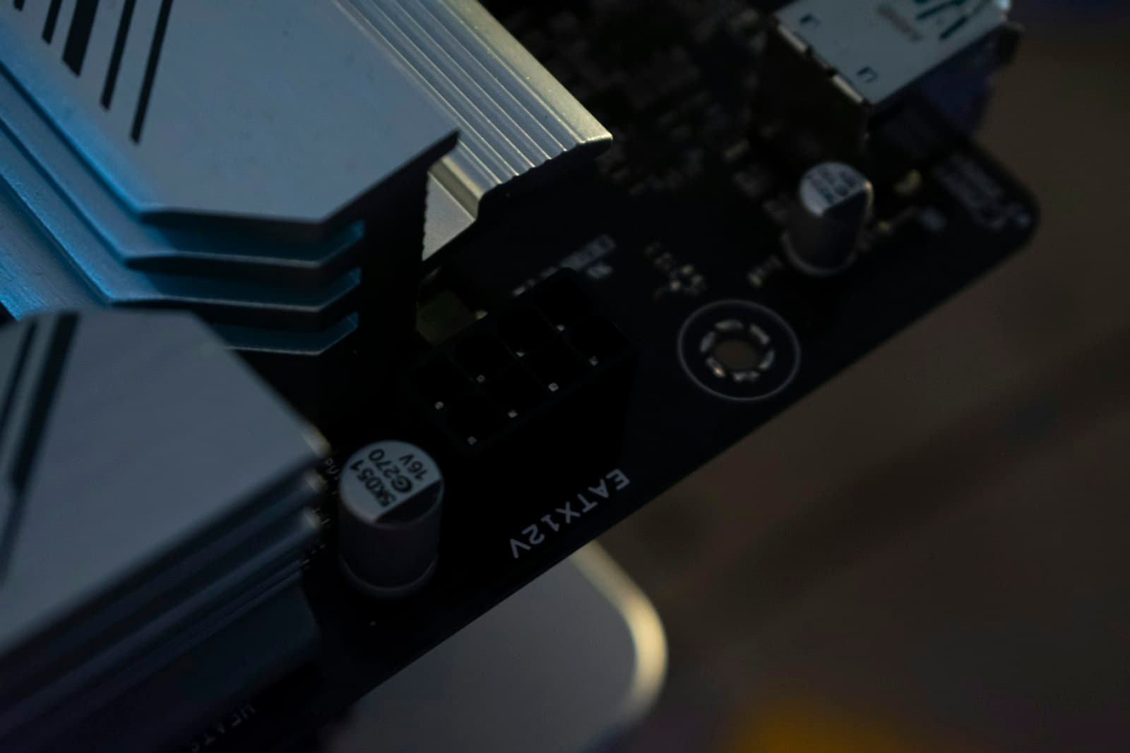 Close-up of the 8-pin EPS CPU power connector area on a motherboard, showing the connector socket near the top-left