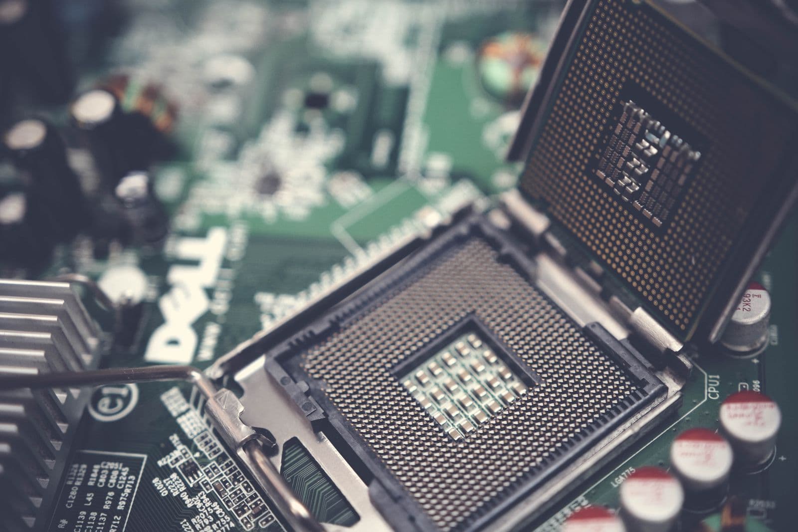 An empty motherboard CPU socket with the pins visible before a chip is installed