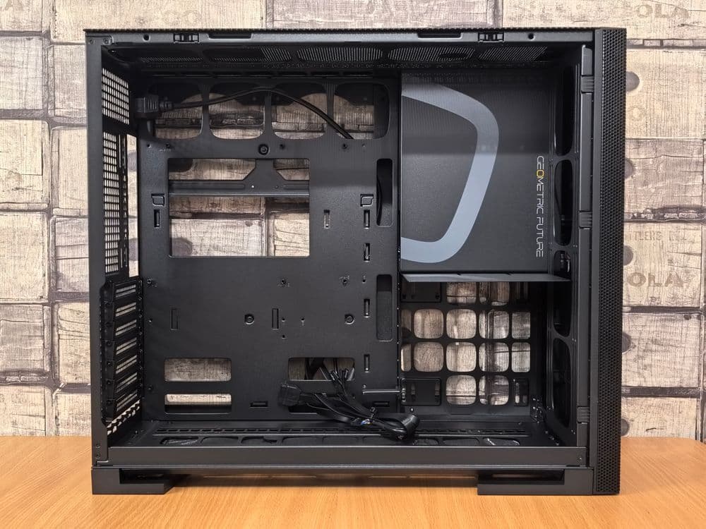 Open interior view of a PC case showing component placement, fan mount positions, and cable routing channels behind the motherboard tray