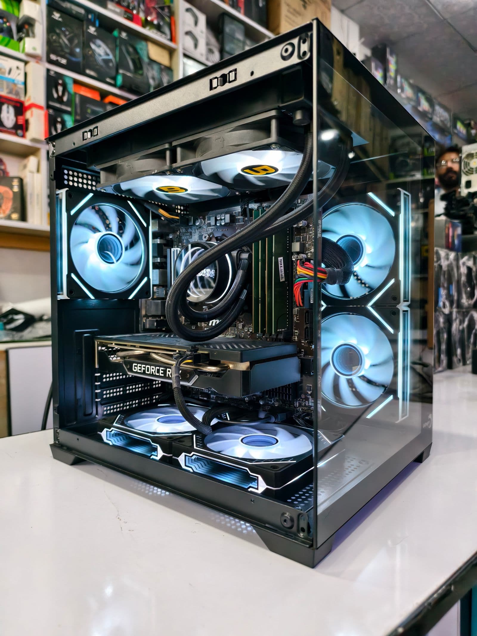 A sleek gaming PC case with visible internal cooling and modern design
