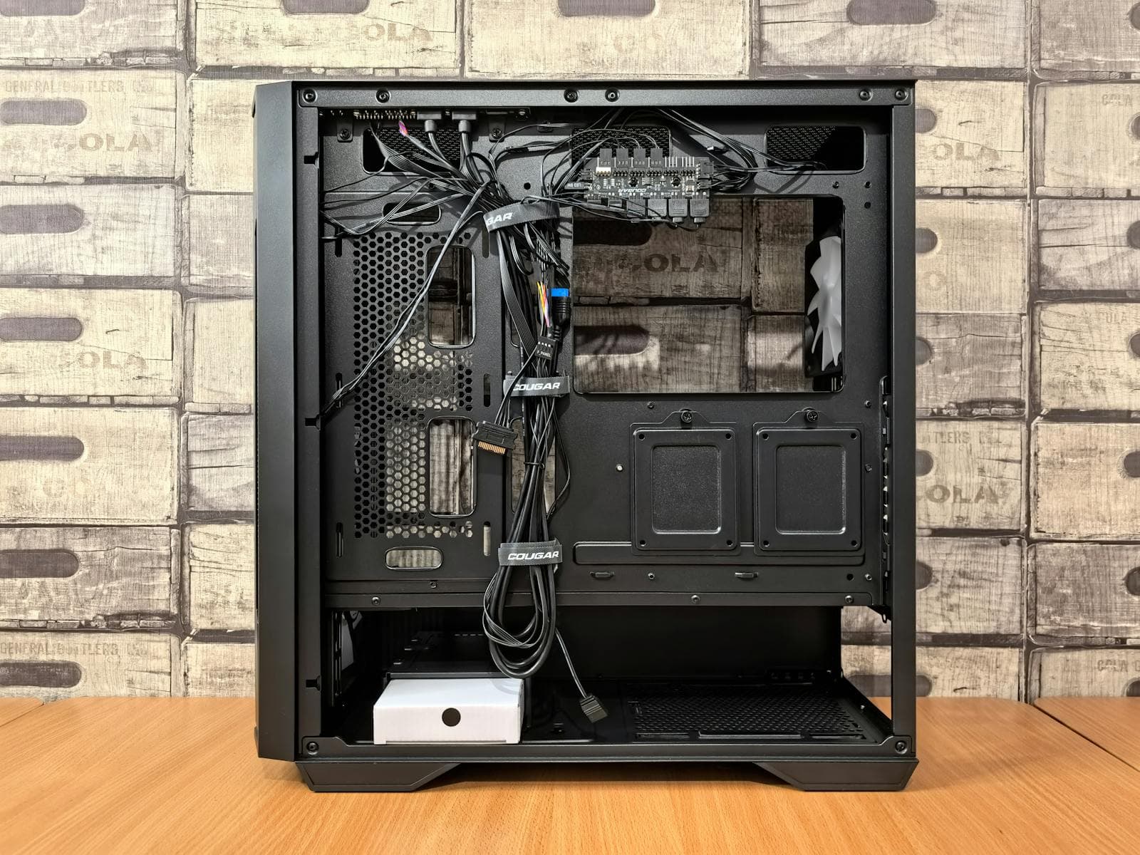 A PC case interior with motherboard, RAM sticks, and cooling components installed, showing full component layout