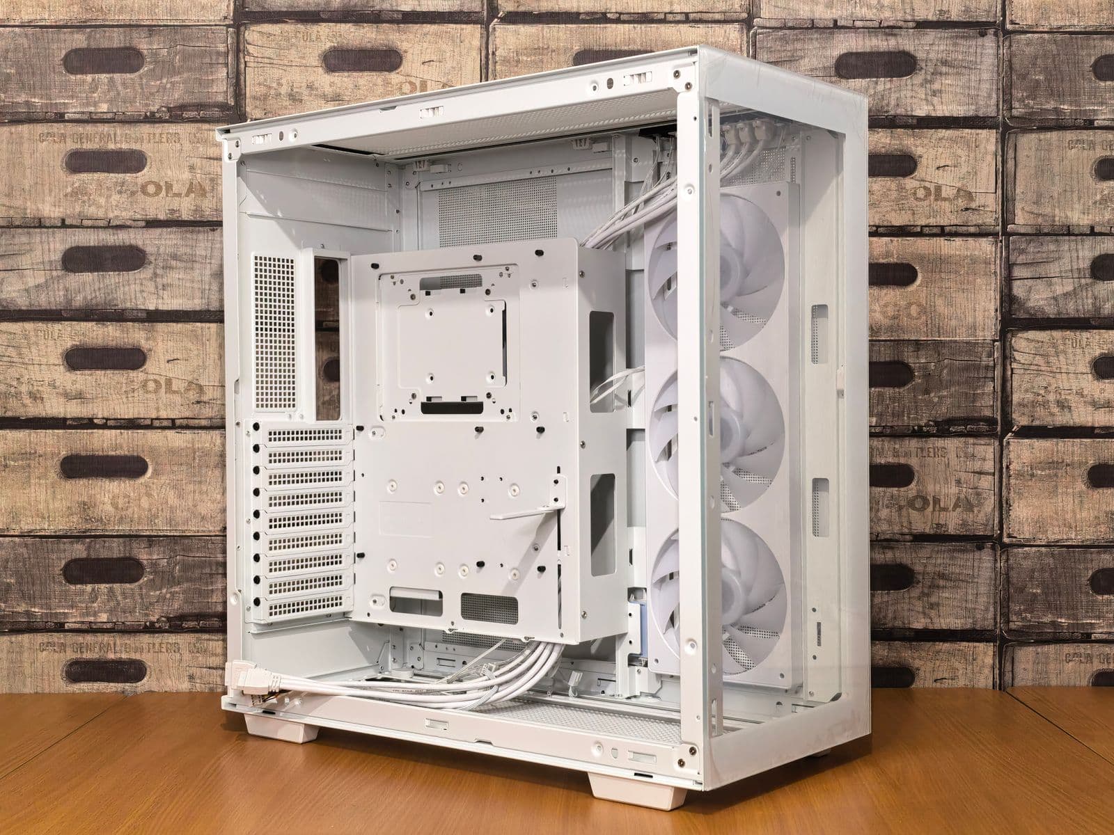 An open white PC case with multiple cooling fans visible