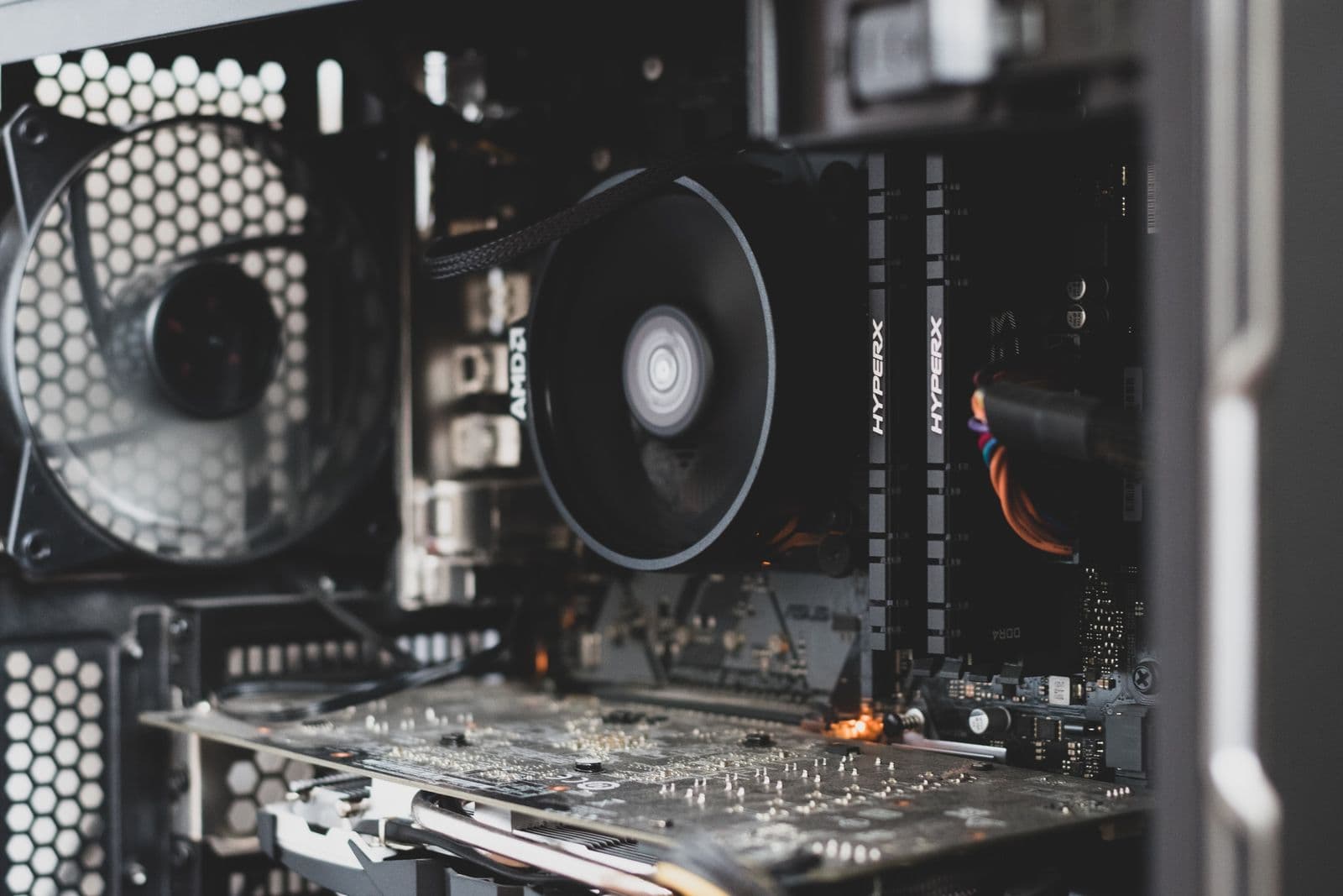 PC internals showing a mounted cooler, installed RAM, and motherboard circuitry on an X870 AM5 build
