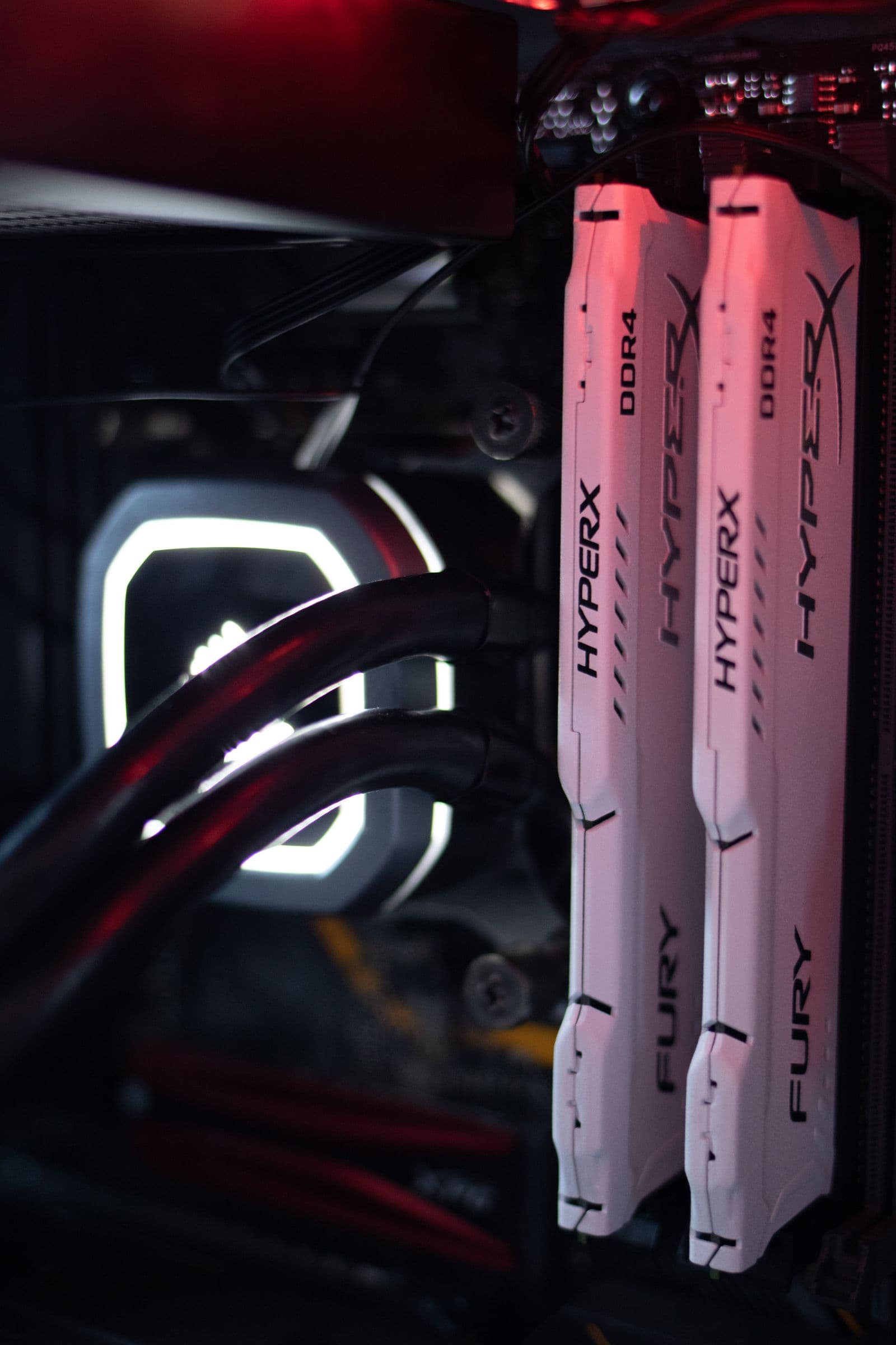 HyperX RAM sticks installed in a gaming PC build with LED lighting and visible motherboard components
