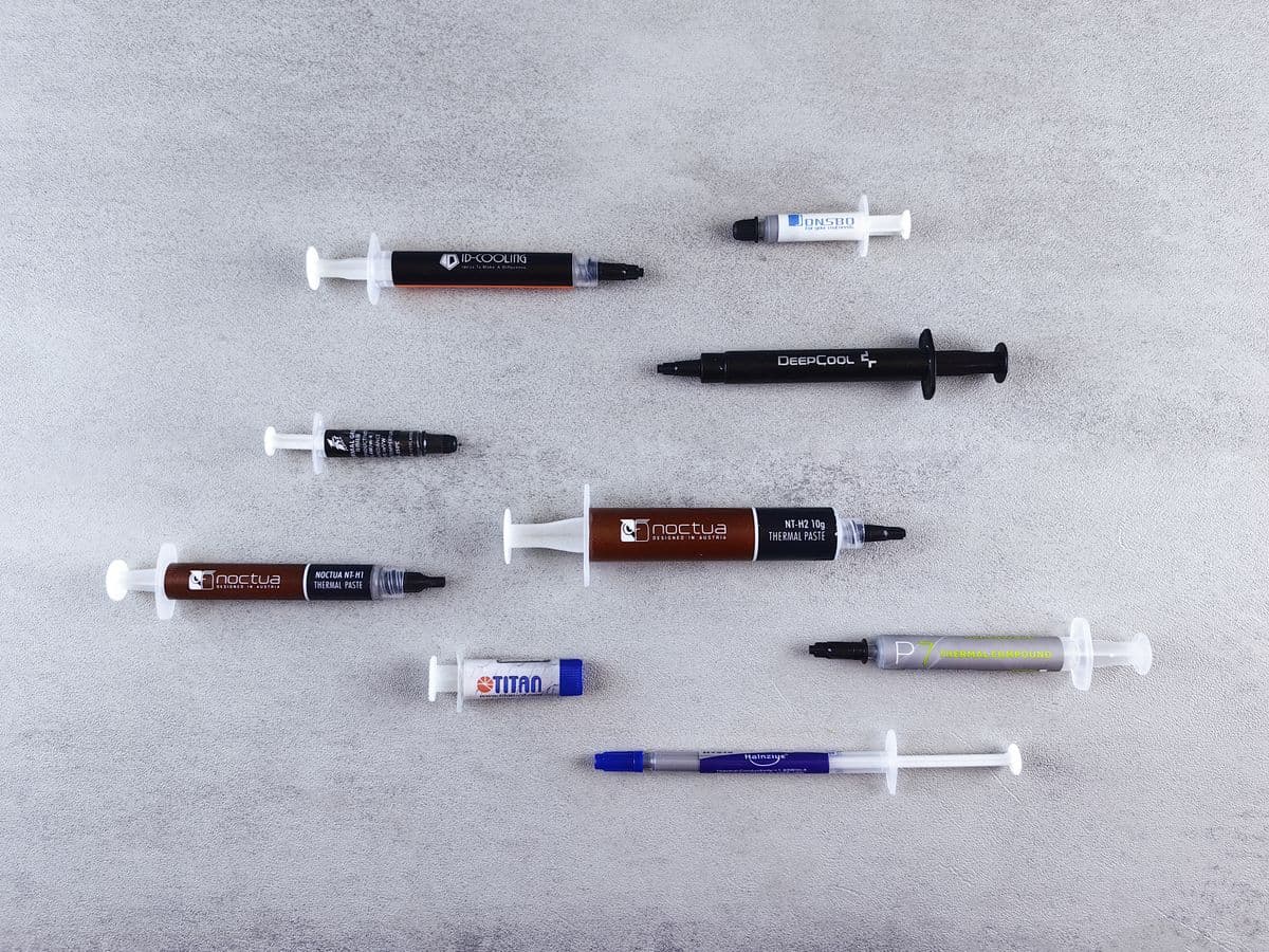 Flat lay of several thermal paste syringes in different sizes